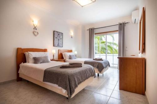 um quarto de hotel com duas camas e uma janela em Villa Estrella - Praia da Luz na Praia da Luz