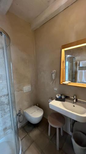 a bathroom with a toilet and a sink and a shower at Antico Mondo Rooms & Suites in Polignano a Mare