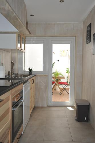 a kitchen with a door leading to a patio at Lagos Central Apartments Ap 10 in Lagos
