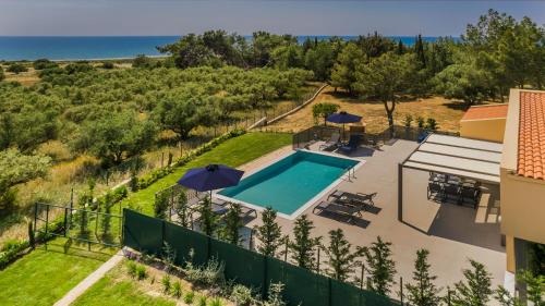 an aerial view of a villa with a swimming pool at SOUND OF SEA Villas in Lixouri