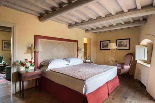 a bedroom with a large bed in a room at Il Borro Relais & Châteaux in San Giustino Valdarno
