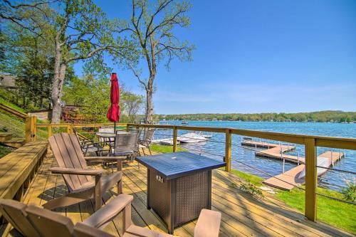 a deck with chairs and a trash can on a lake at Serene Lakefront Escape Boat Dock and Grill! in Twin Lakes