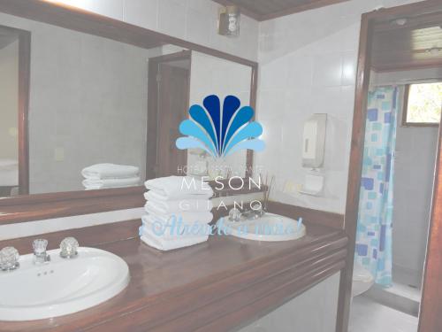 a bathroom with a sink and a mirror at Hotel y Restaurante Mesón del Gitano in Caucasia