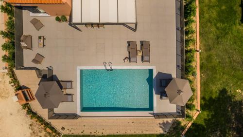 an overhead view of a swimming pool in a house at SOUND OF SEA Villas in Lixouri