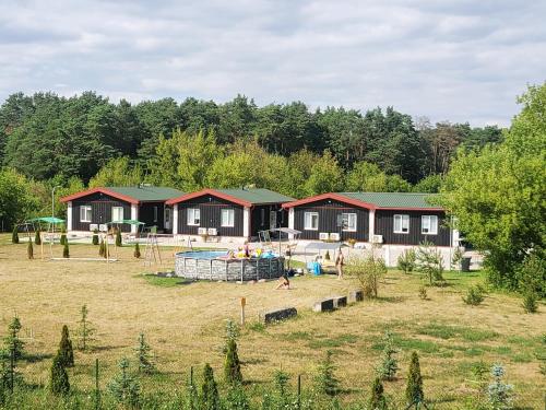 a house with a playground in a field at Hotel Green Smiltynė in Panevėžys