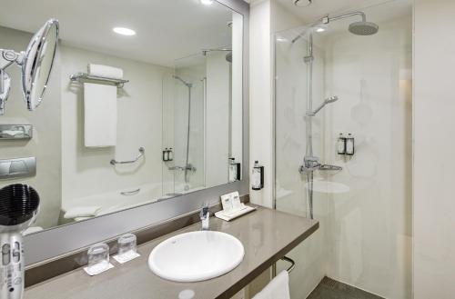 a bathroom with a sink and a mirror at Sercotel Caspe in Barcelona