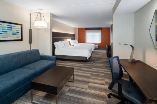 a hotel room with a bed and a couch at Holiday Inn Express Hotel & Suites Bluffton at Hilton Head Area by IHG in Bluffton