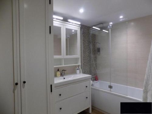 a white bathroom with a sink and a shower at Precioso apartamento junto a playa y con piscina. in Málaga