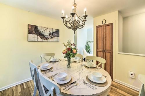 a dining room with a table with chairs and a chandelier at Family-Friendly Retreat with Hot Tub 1 Mi to Dtwn in Saratoga Springs