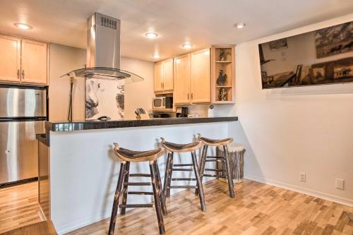 a kitchen with a counter and stools at a bar at Skiers Dream Upscale Condo By Teton Village! in Wilson