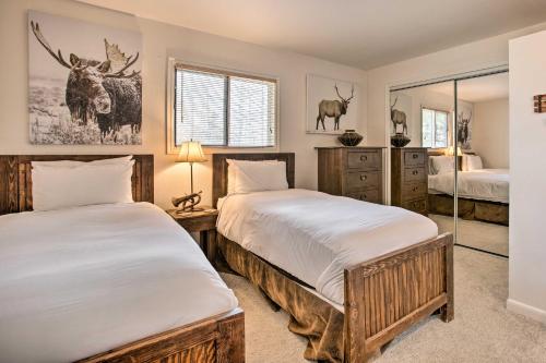 a bedroom with two beds and a mirror at Skiers Dream Upscale Condo By Teton Village! in Wilson
