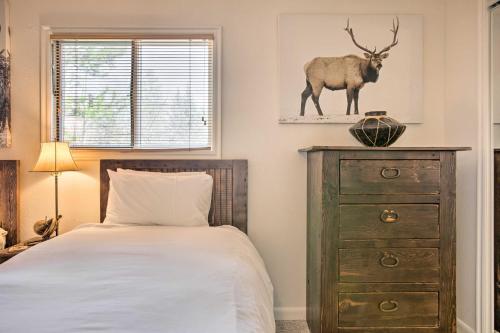 a bedroom with a bed and a dresser with a deer on the wall at Skiers Dream Upscale Condo By Teton Village! in Wilson