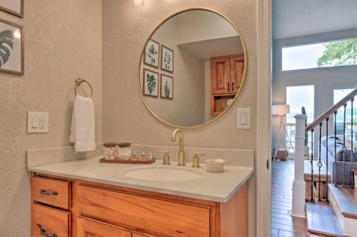 a bathroom with a sink and a mirror at Private Boat Slip Serene Lake of the Ozarks Home in Lake Ozark