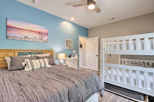 a bedroom with a large bed and a crib at Grill and Fire Pit Blue Cabin Ozarks Getaway! in Camdenton