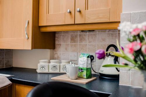 a kitchen counter top with a coffee maker and cups at Sleeps 5 - 3 Bedrooms - walk to the square hosted Happy Valley cast in Hebden Bridge