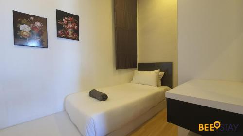 a small room with two beds in it at The Wave Suites Melaka in Melaka