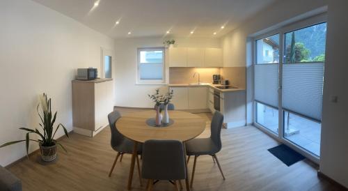 a kitchen and dining room with a table and chairs at Ferienwohnung Ott in Ebbs