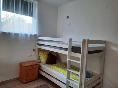 two bunk beds in a room with a window at Pension Horvath in Sankt Kanzian