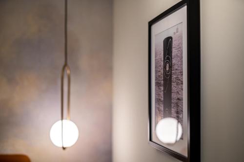 two lights hanging on a wall next to a picture at Cielo e Nuvole in Cagli