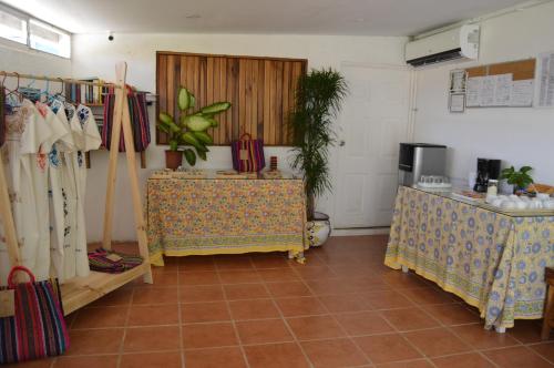 a room with two tables and a counter in a room at Hotel Indalo adults only in Puerto Viejo