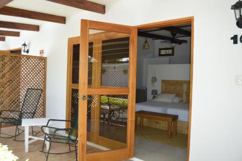 a room with a door leading to a bedroom at Hotel Indalo adults only in Puerto Viejo