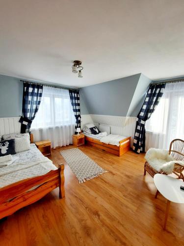a bedroom with a bed and a couch in a room at Apartament U Maćków in Murzasichle