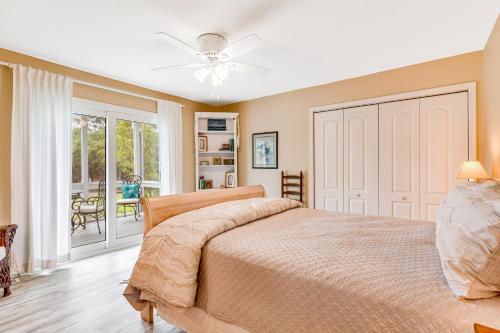 a bedroom with a bed and a sliding glass door at Heh Edisto in Edisto Beach