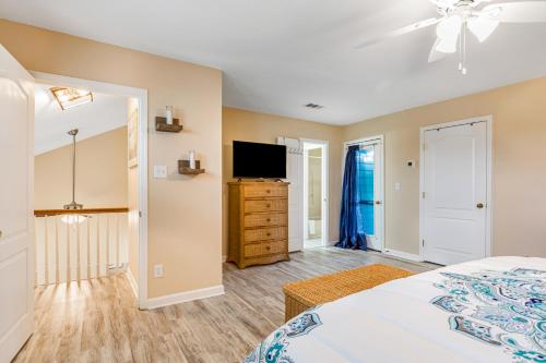a bedroom with a bed and a flat screen tv at Heh Edisto in Edisto Beach