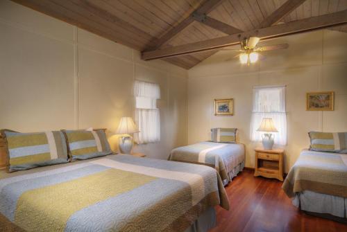 a bedroom with two beds and a ceiling at Banning House of Two Harbors in Two Harbors