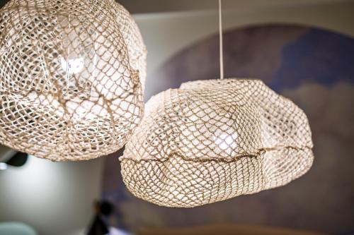 two lights hanging from the ceiling in a room at Cielo e Nuvole in Cagli