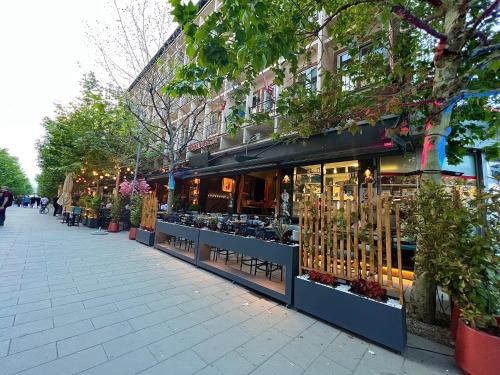 a store front of a street with a lot of plants at HOTEL LYBETEN in Ferizaj