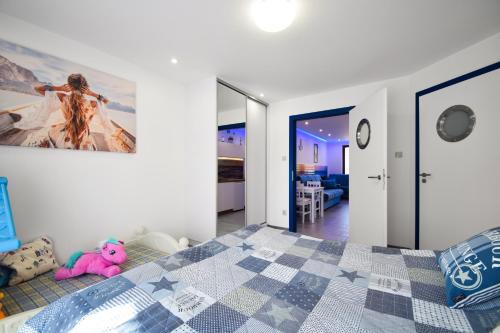 a bedroom with a bed with a tiled floor at Dafne1 apartamenty in Niechorze