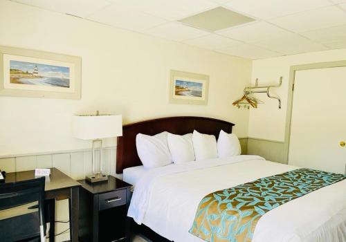 a hotel room with a large bed and a desk at Wells Moody Motel in Wells