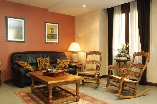 a living room with a couch and two chairs at Hotel Pirineos in Castejón de Sos