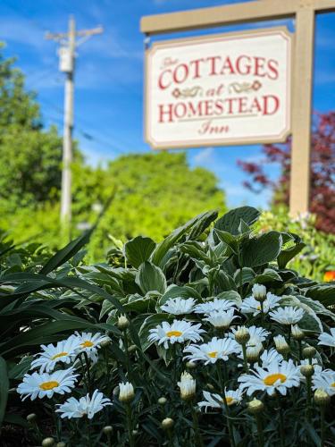 a sign for a garden with white flowers and a sign at Homestead Inn - Blowing Rock in Blowing Rock