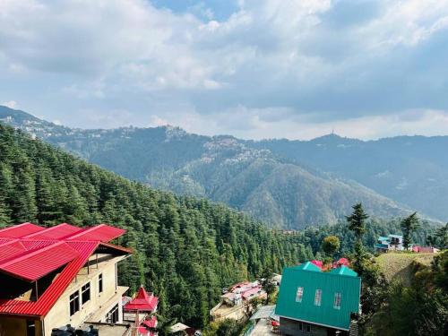 a view of a mountain with houses and trees at Residence Inn Homestay in Shimla