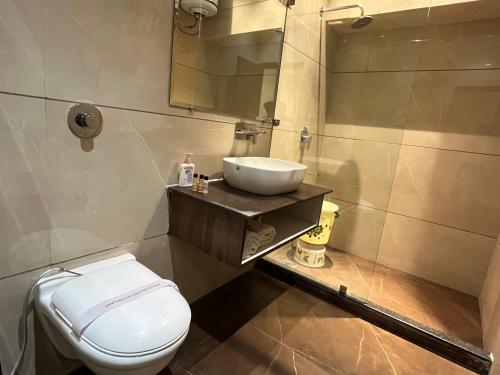 a bathroom with a sink and a toilet at Hotel Exotic - 5 min walk from Golden Temple in Amritsar
