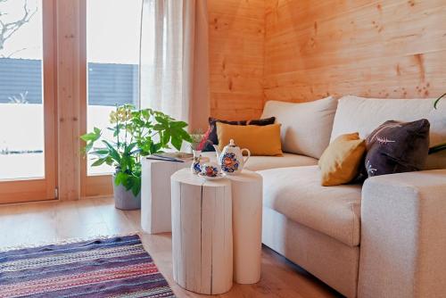 a living room with a couch and two tables at Osada Gąsienica Centrum Zakopane in Zakopane