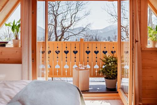 a bedroom with a window with a view of the mountains at Osada Gąsienica Centrum Zakopane in Zakopane