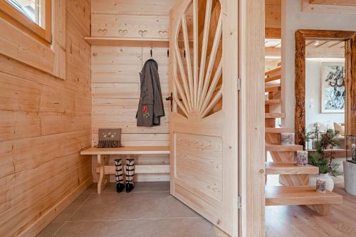 a wooden cabin with a door leading into a sauna at Osada Gąsienica Centrum Zakopane in Zakopane