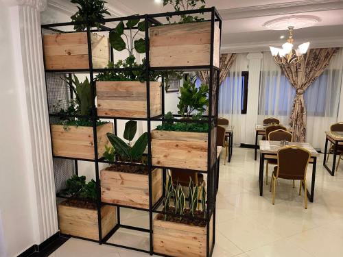a vertical plant tower with wooden boxes and plants at HOTEL LES ARCADES in Abomey-Calavi