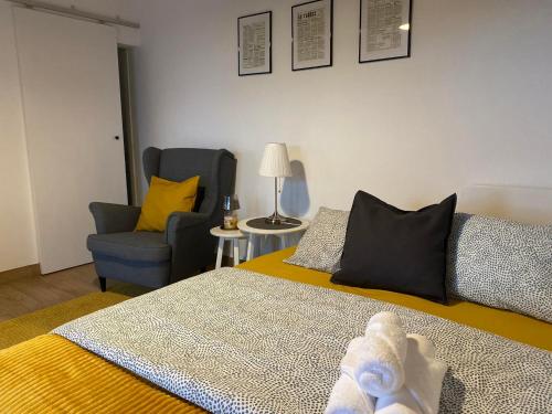 a bedroom with a bed and a chair and a couch at Palheiro da Moenda in Lajes das Flores