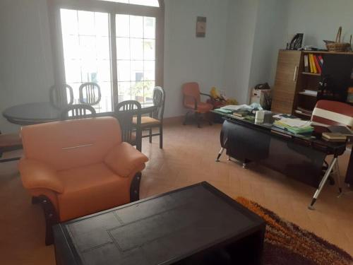 a living room with a table and a chair and a tablektop at Super luxurious villa with large landscape areas in Cairo