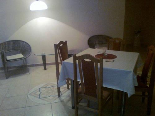 a dining room with a white table and chairs at Villa Paradiso in Wrocław