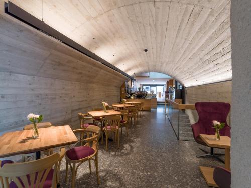 a dining room with wooden tables and chairs at Platzhirsch Kufstein in Kufstein