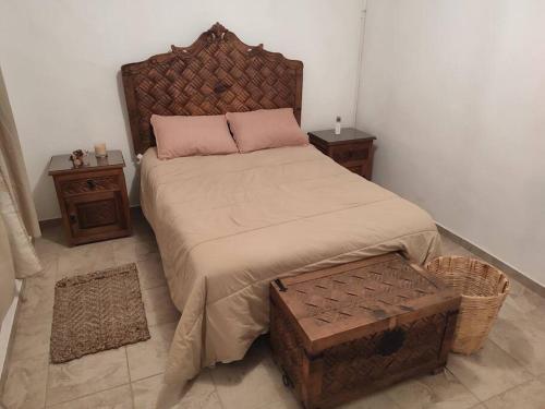 a bedroom with a large bed and two night stands at Casa Mango amplia con alberca y cerca de la Media Luna !!! in Río Verde