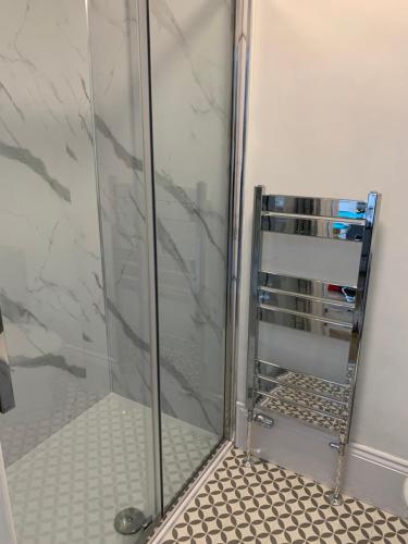 a shower in a bathroom with a glass door at Central Whitby Seaglass studio in Whitby