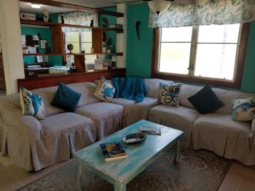 a living room with two couches and a coffee table at River Bend Resort Bze in Belize City