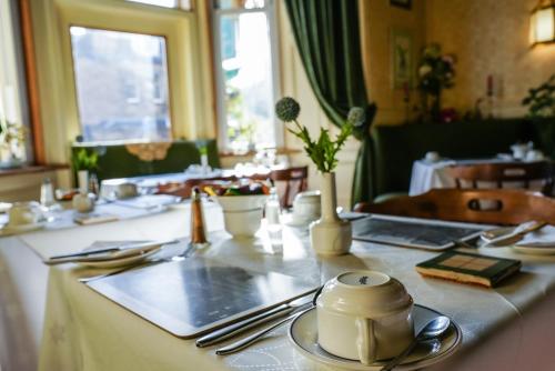 a table with a tea pot on top of it at Rosehall Hotel in Edinburgh
