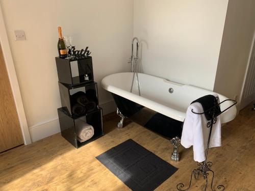 a bathroom with a bath tub in a room at Central Whitby Seaglass studio in Whitby